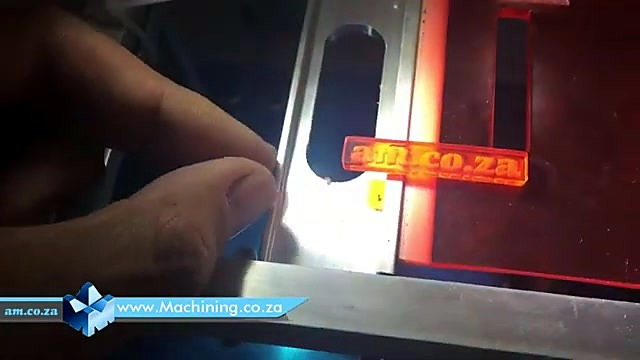 Orange Perspex workpiece in metal fixture (SKU ask)