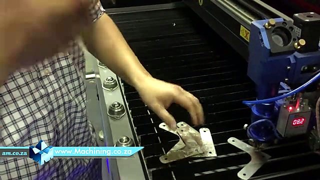 Metal workpiece on slat bed + height readout (SKU ask)