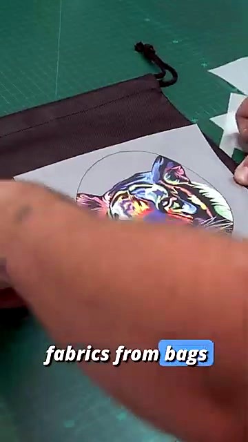 Colorful transfer placed on black fabric bag (SKU ask)