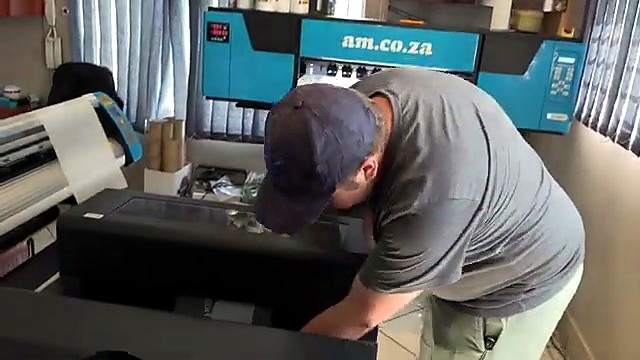 CLEAR am.co.za blue DTF roll printer during tote job (SKU ask)