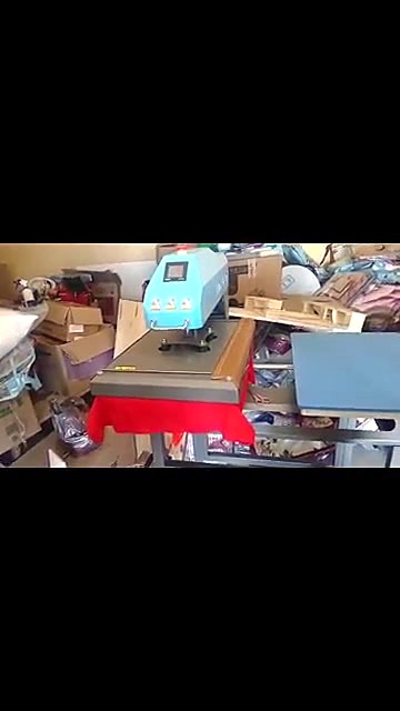 H-Press/6080D twin-station heat press in the workshop with a red T-shirt on the platen