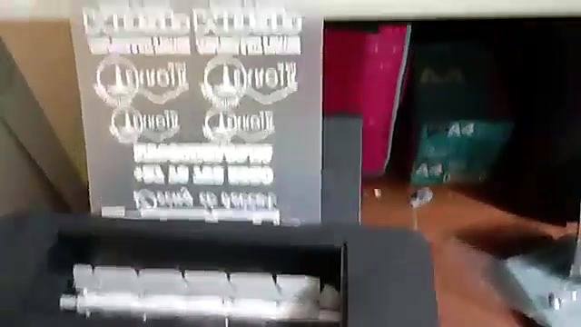 Film feeding into powder shaker slot (SKU ask)