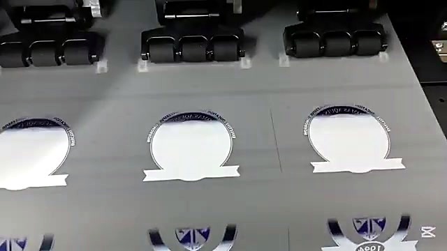 Pinch rollers over crest logos mid-print (SKU ask)
