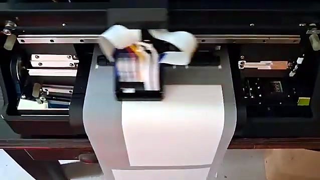 XP600 printhead carriage with ink damper tubes moving over the DTF film