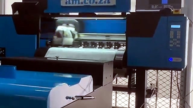 Printer carriage mid-print on blue crossbeam body (SKU ask)
