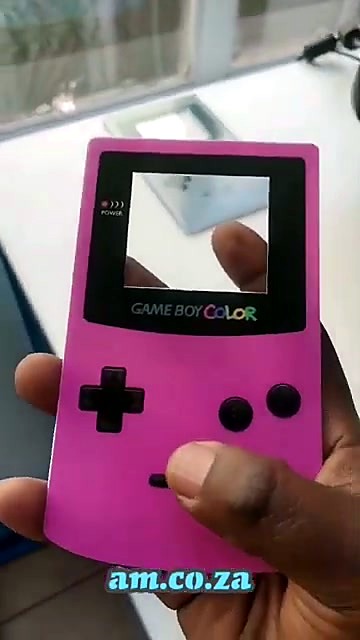 Finished pink Game Boy Color Perspex faceplate held up (SKU ask)