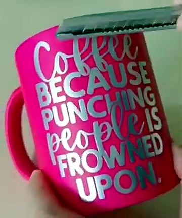 Utility knife scraping silver UV-DTF letters on mug (SKU ask)