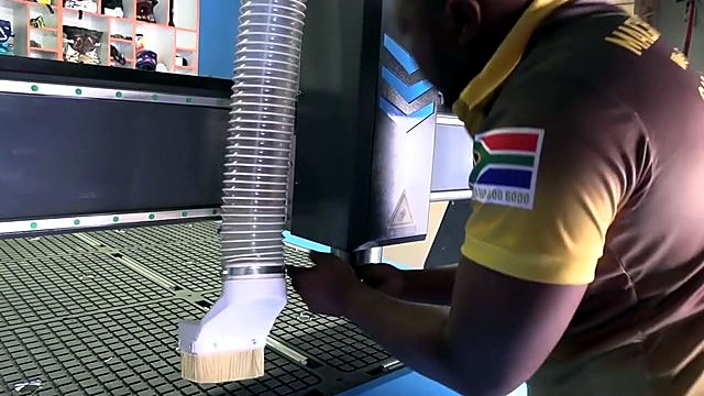 White brush-skirt dust hood + clear corrugated hose on spindle (SKU ask)