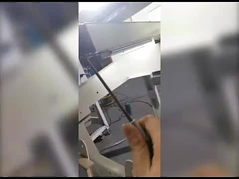 Hand + probe toward embroidery head internals (SKU ask)