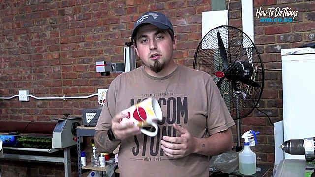 Presenter shows finished mug bottom mark (SKU ask)