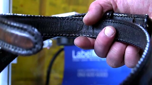 CLEAR LabelMark chassis plate behind black leather belt (SKU ask)
