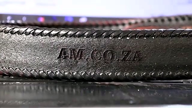 Finished deep AM.CO.ZA relief on braided leather belt (SKU ask)