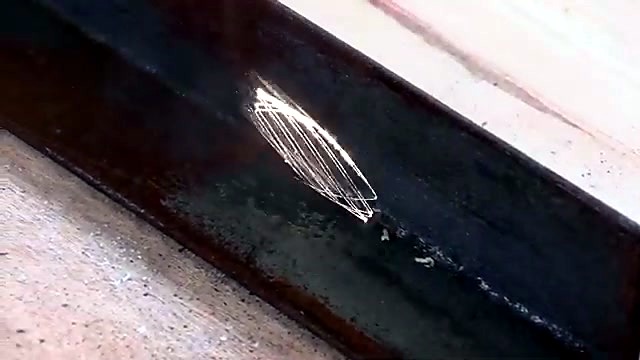 Oval clean metal revealed on rusted bar (SKU ask)