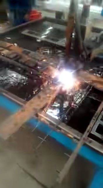 Metal cut in progress — sparks over slatted bed (SKU ask)