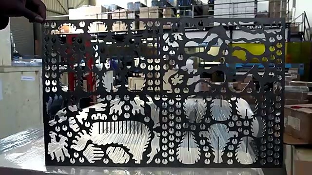 Operator holding nested 3mm steel cut sheet (SKU ask)