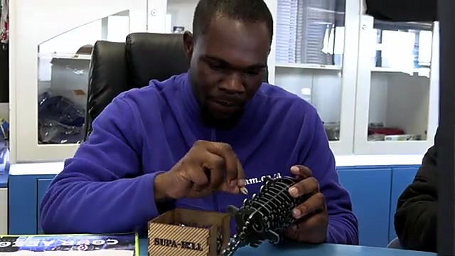 Assembling 3D steel puzzle/model at desk (SKU ask)