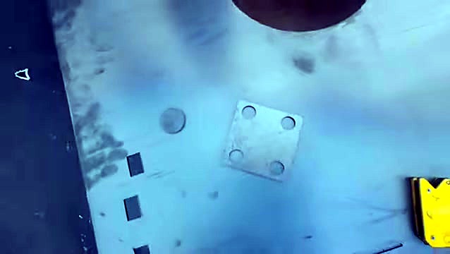 Cut mild-steel parts close-up on plate (SKU ask)