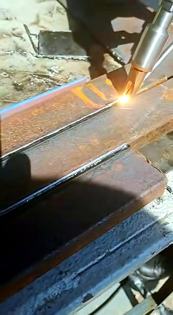 Handheld fibre head along rusted metal seam (SKU ask)