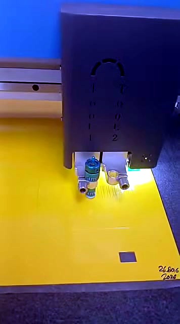 Close-up TOOL 1 / TOOL 2 labels on dual tool head; yellow sheet (SKU ask)