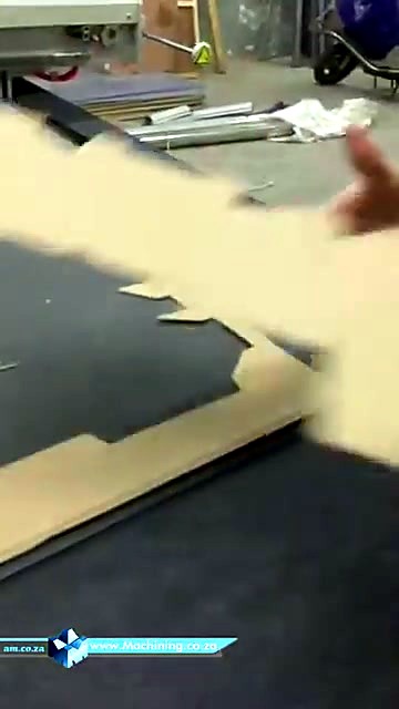 Hands lifting cut/creased cardboard blank (SKU ask)