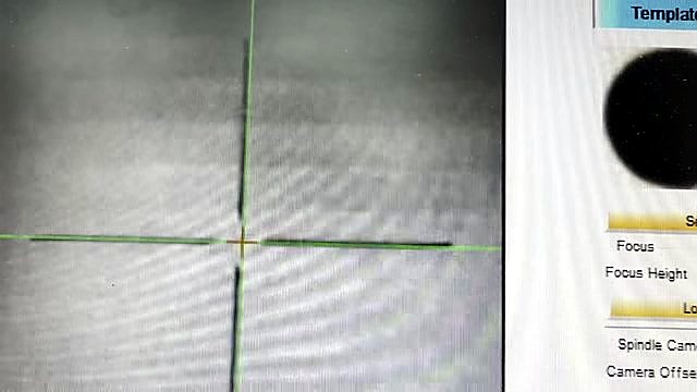 CCD live grey feed with green crosshair on mark (SKU ask)
