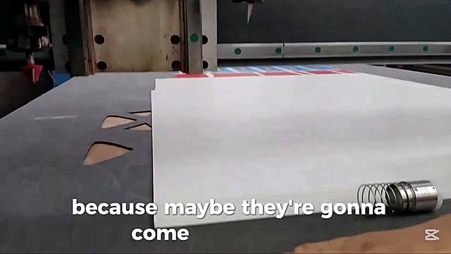 Tool head over white sheet on vacuum-style bed (SKU ask)