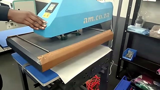 am.co.za heat press; operator presses activation button (SKU ask)