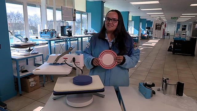 Plate-press demo with printed plate in hand (SKU ask)