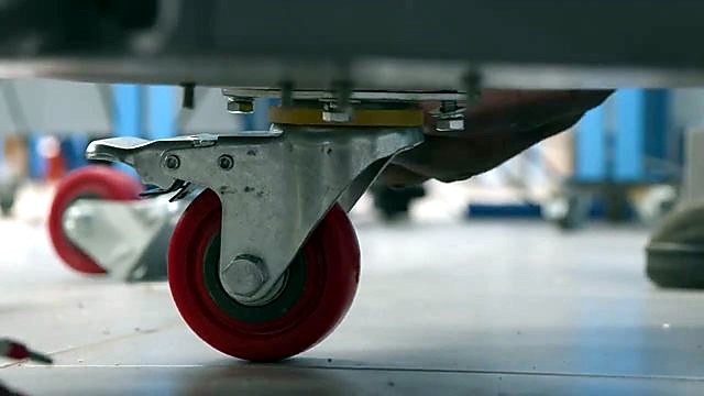 Red heavy-duty caster on grey H-ROLLER base (SKU ask)