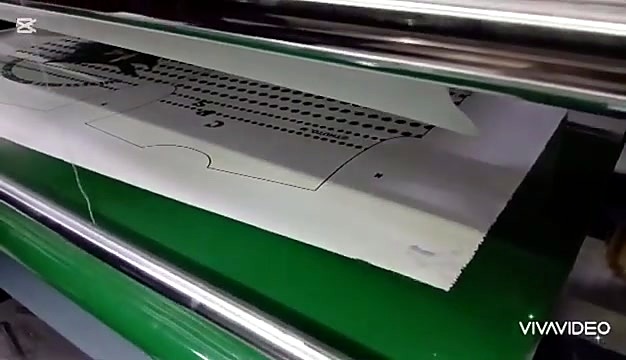 Green belt feeding Mickey layout into rollers (SKU ask)