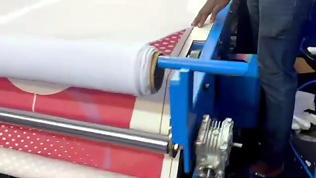 Fabric roll feeding into the 1700mm oil roller heat press