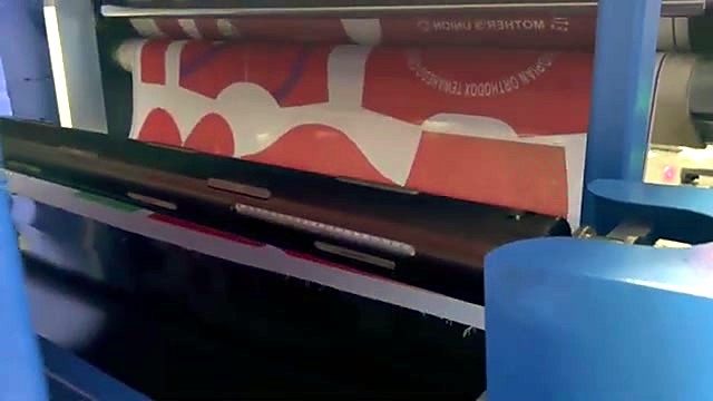 Sublimation-printed fabric entering the heated drum