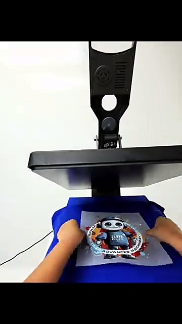 Hands place robot DTF film on blue shirt (SKU ask)