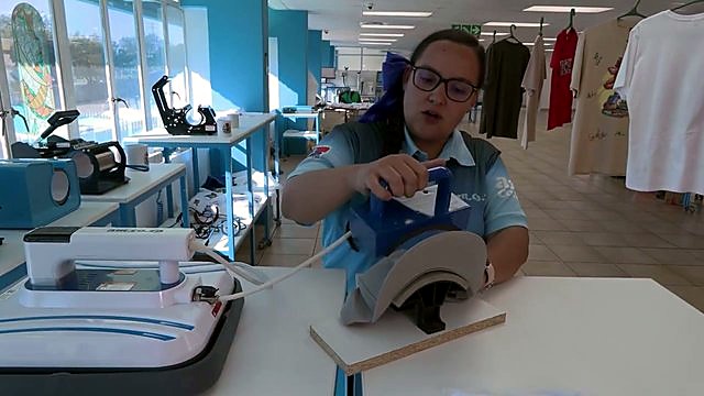 Tech operating blue cap press in showroom (SKU ask)