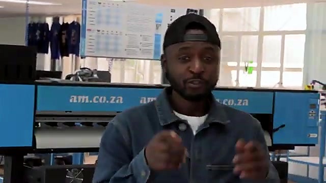 Presenter + am.co.za large-format machine behind (SKU ask)