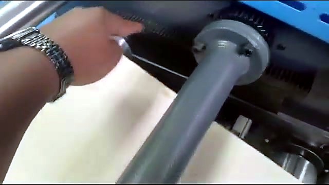 Adjusting tension roller on blue frame