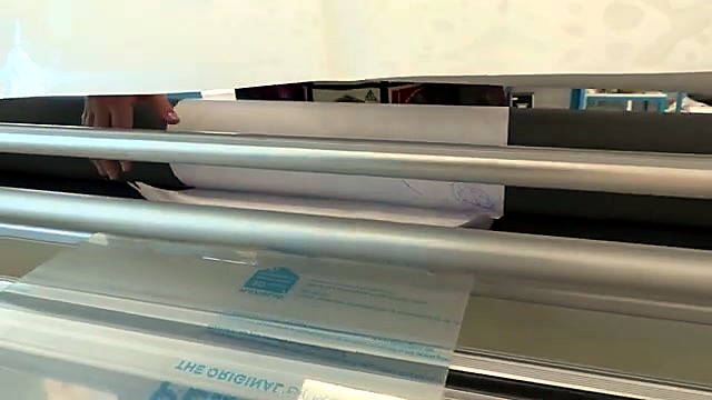 Peeling laminate liner into rollers (SKU ask)