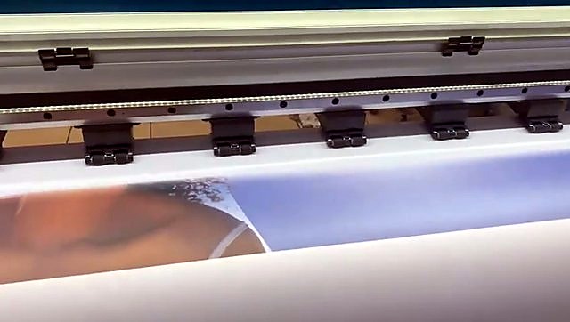 Pinch rollers holding vinyl mid commercial banner print (SKU ask)