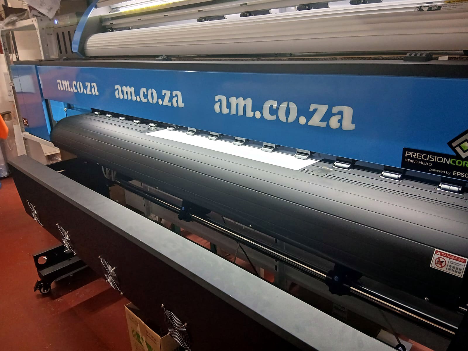F1-1800 FastColour front: am.co.za blue panel, Epson PrecisionCore, cooling fans (staff still)