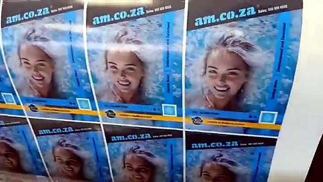 Close printed am.co.za poster grid on media (SKU ask)