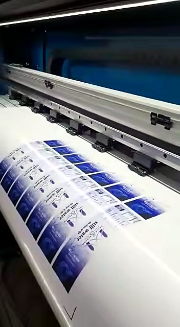 Carriage on rail over rows of blue labels (SKU ask)