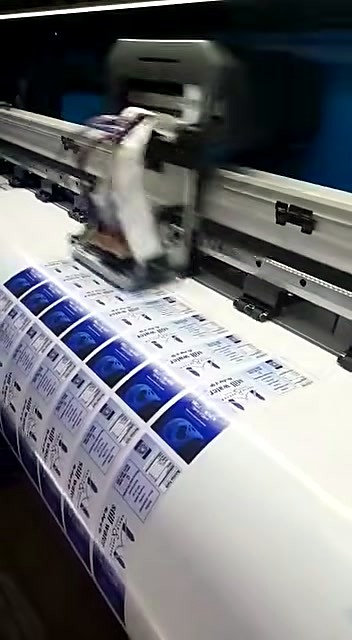 Printed blue rectangular labels progressing on media (SKU ask)