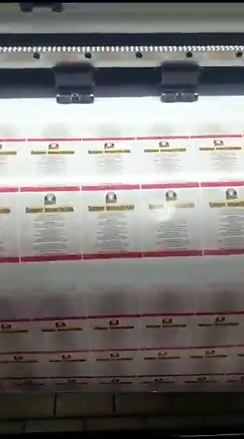 Pinch rollers holding white roll media (SKU ask)