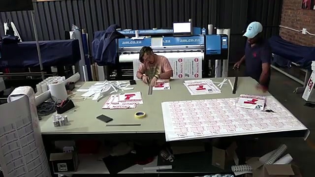 Apply printed vinyl onto ABS boards on table (SKU ask)