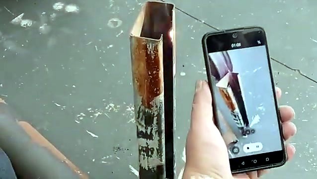 Phone filming the laser-cleaned steel channel
