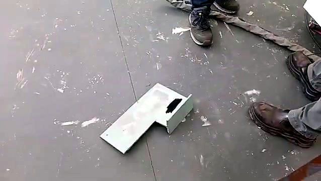 Laser paint-off patch removed to bare metal on a green painted bent steel plate