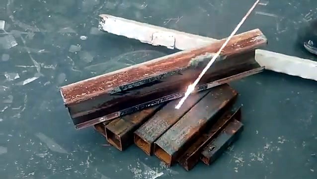 Spark streak during laser rust-off on the steel angle