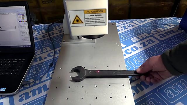 LabelMark white galvo head over wrench on T-slot bed (SKU ask)