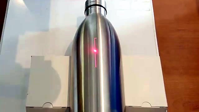 Stainless bottle in jig + red pilot crosshair (SKU ask)