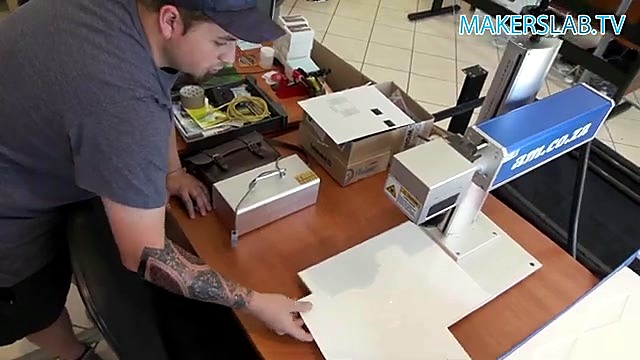Technician loads white tile on LabelMark bed (SKU ask)
